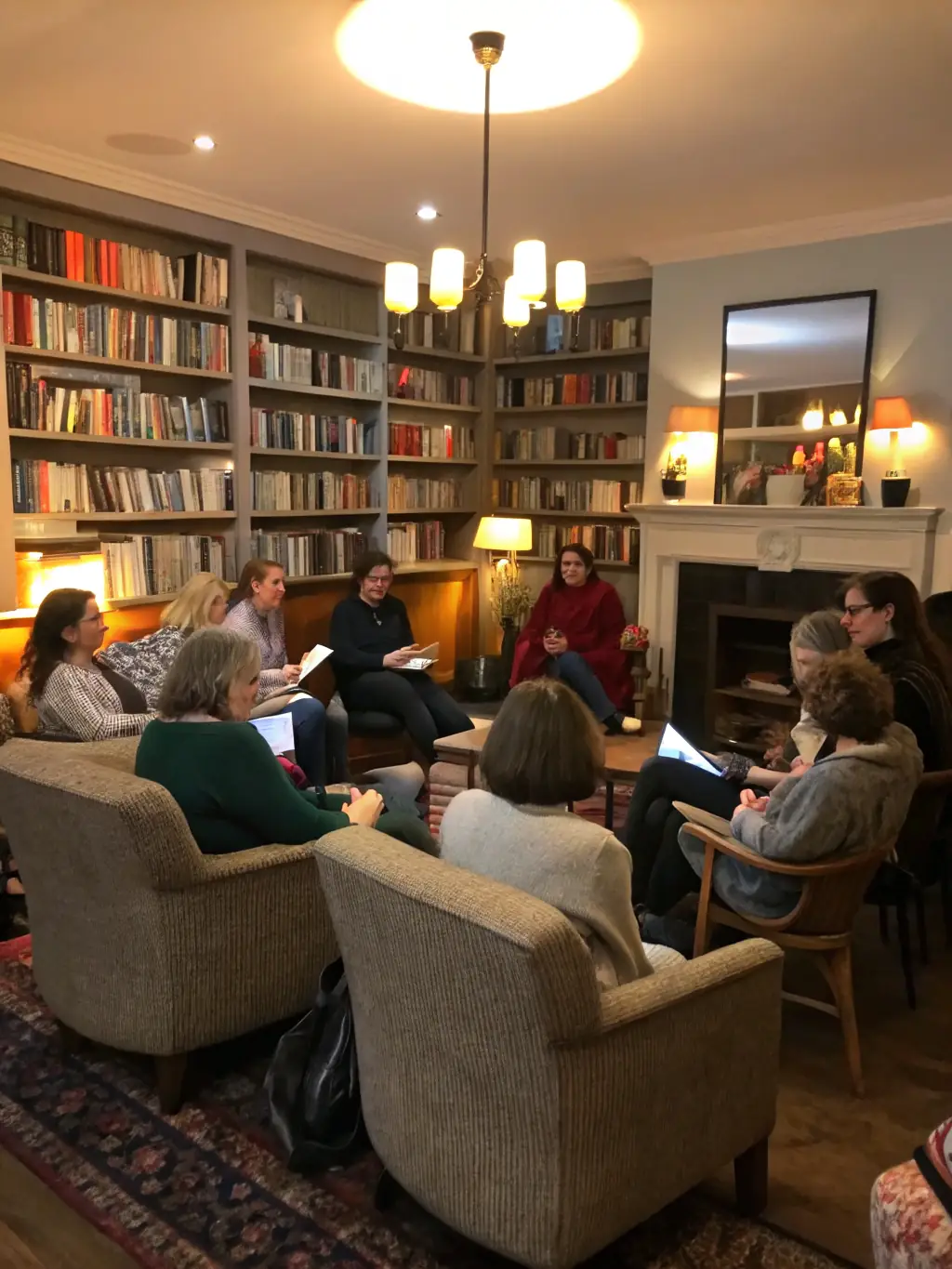 A group of people sitting in a circle discussing a book, highlighting the reading groups and literary discussions facilitated by AMICALE LAIQUE DE MAROMME.